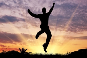 Silhouette of a man jumping in the sunset